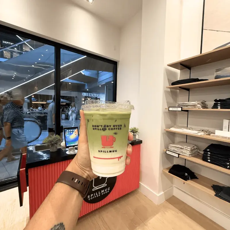 Spillmug matcha served inside a Vuori Clothing retail pop-up activation